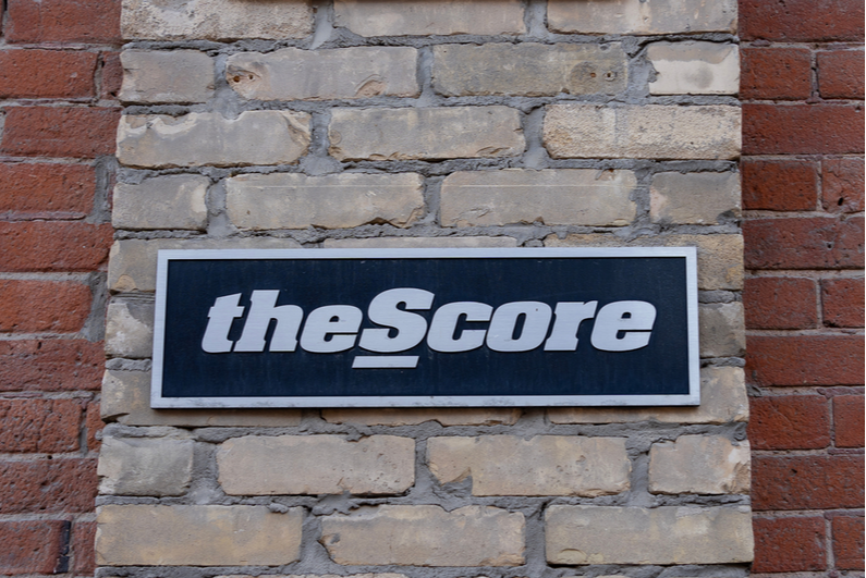 theScore sign on a brick wall