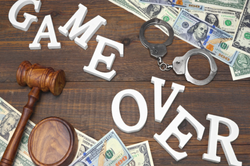 GAME OVER amid cash and handcuffs