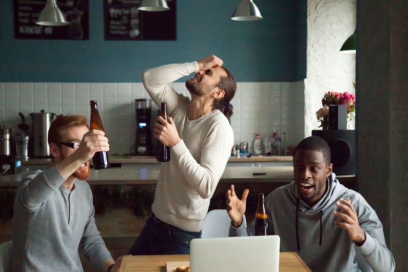 Three guys watching sports