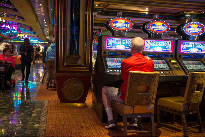 Old man playing video poker