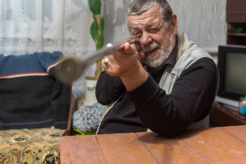 Man pointing his cane like a gun