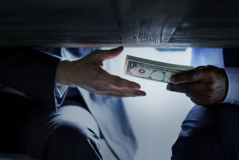 Person handing cash under table