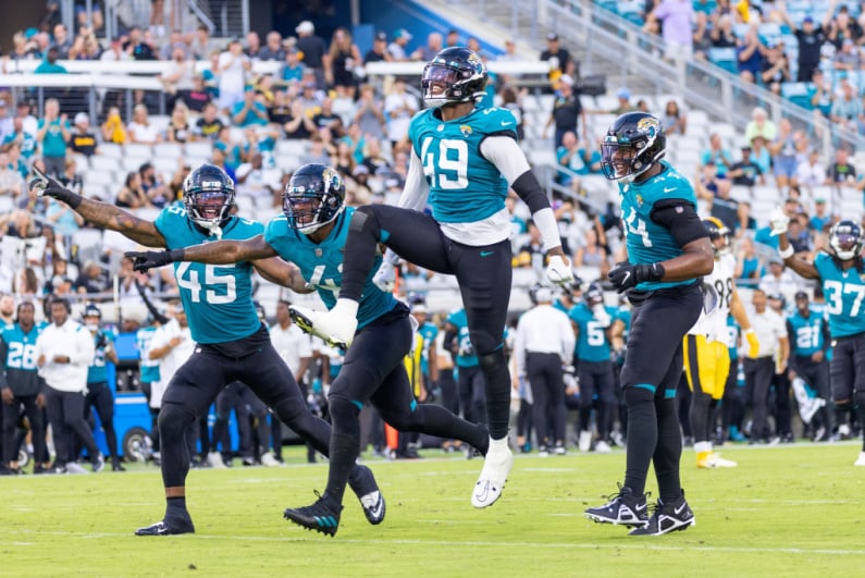 Jacksonville Jaguars players celebrating during a 2022 preseason game against the Pittsburgh Steelers