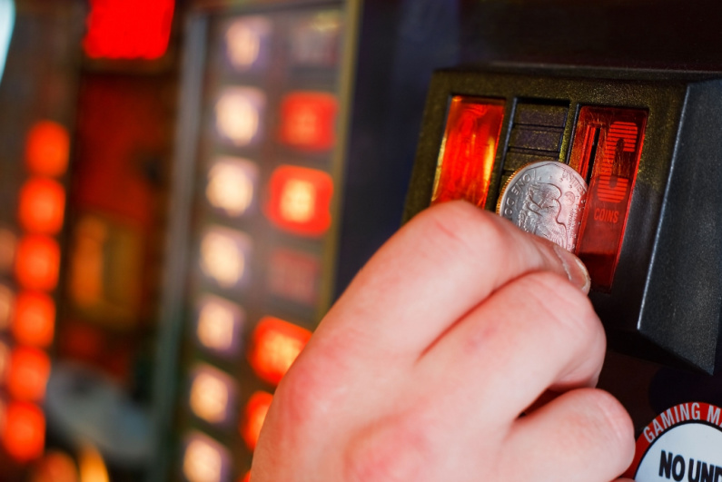 Person putting money into slot machine