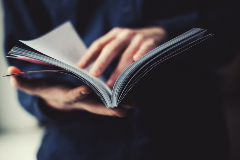 Man flipping through magazine