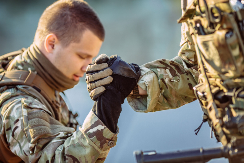 Soldier helping another soldier