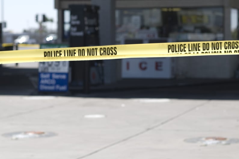 Police tape at a gas station