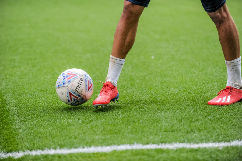 Close-up of a soccer player's feet dribbling the ball
