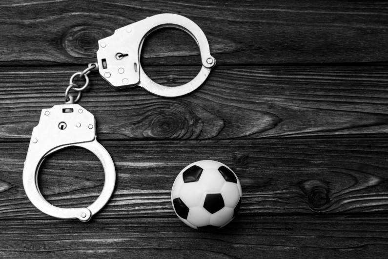 Handcuffs and soccer ball