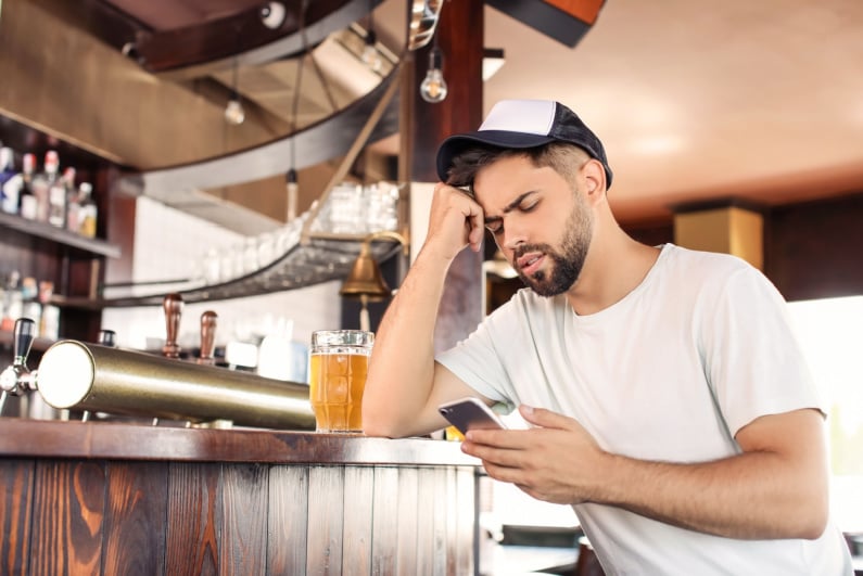 Sad bettor at bar