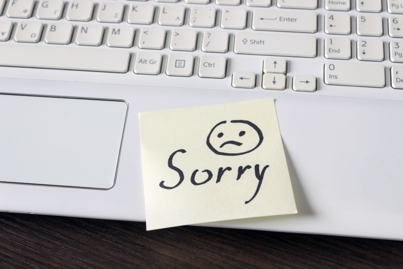 "Sorry" post-it on a keyboard