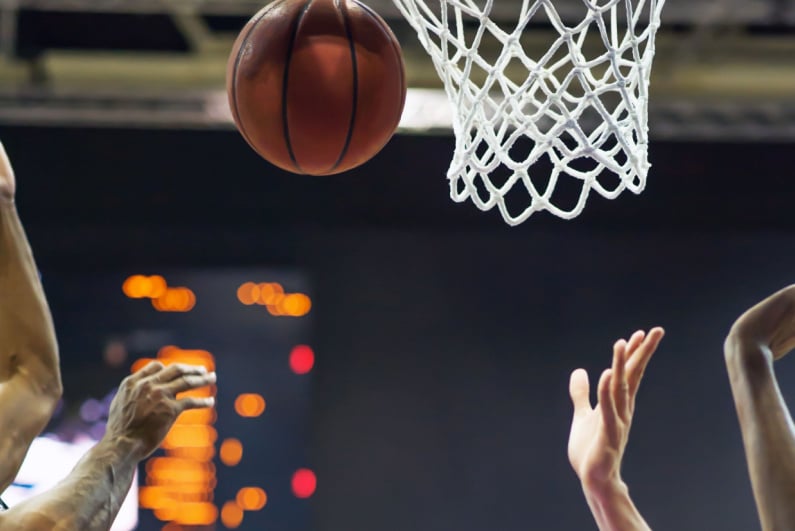 Closeup of basketball player going for a rebound