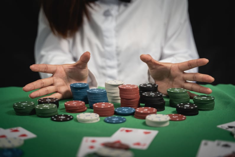 Poker player collecting chips