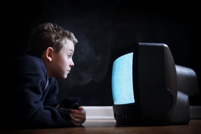 Boy watching static on TV