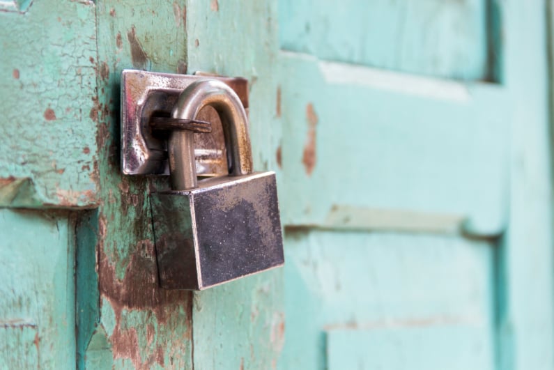 Padlock on a weathered door