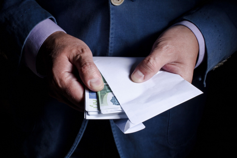 Man taking cash out of an envelope