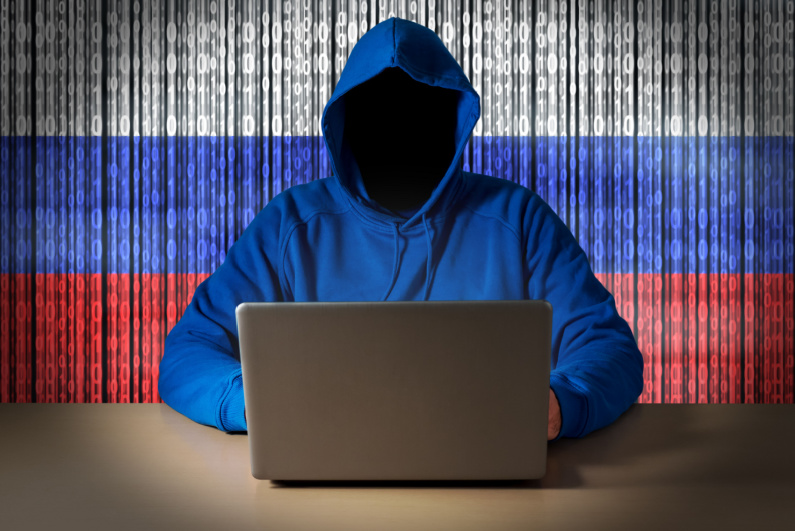 Hacker in front of Russian flag