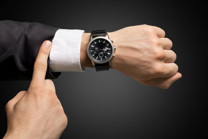 Businessman looking at watch