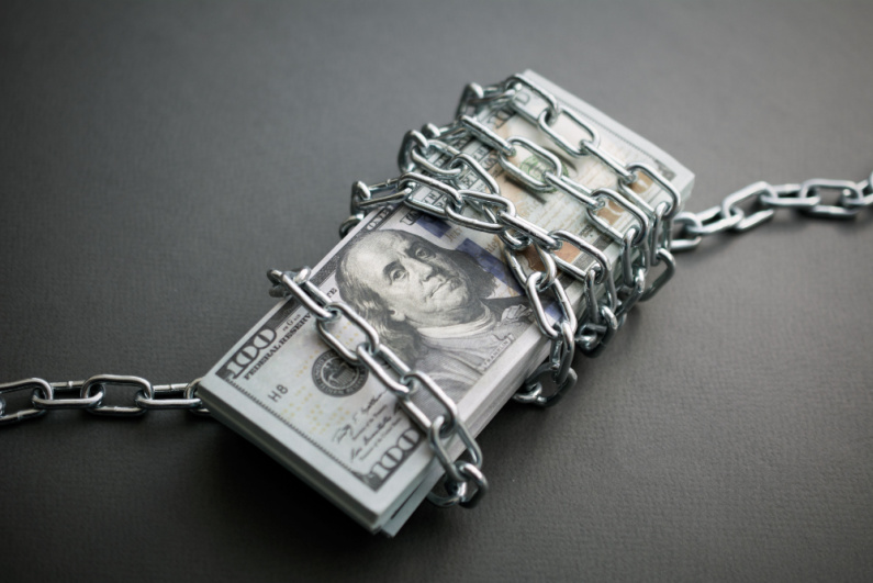 Brick of money wrapped in a chain