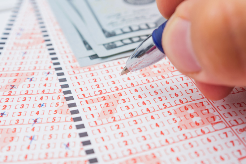 Person filling out lottery tickets