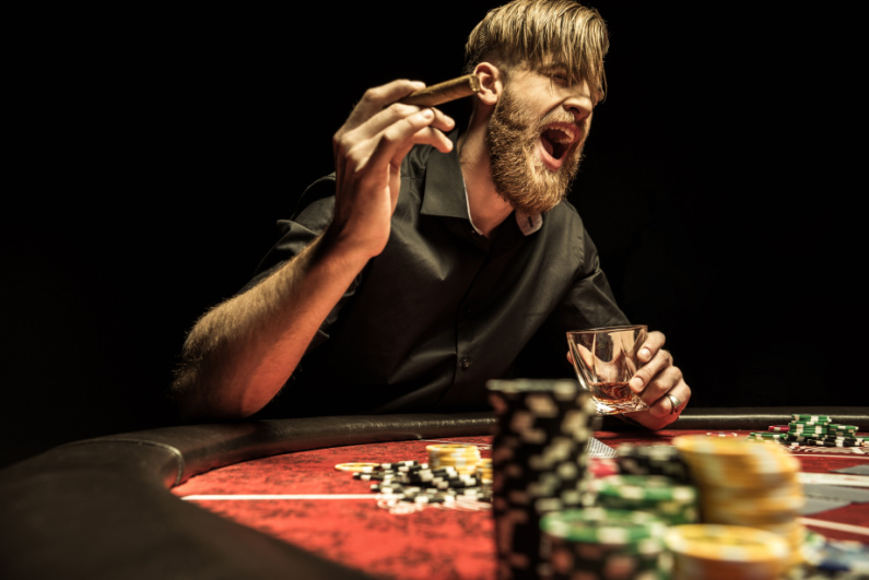 Poker player with a cigar and drink yelling across the table