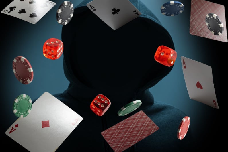 Cards, dice, and chips floating around shadowy hooded figure