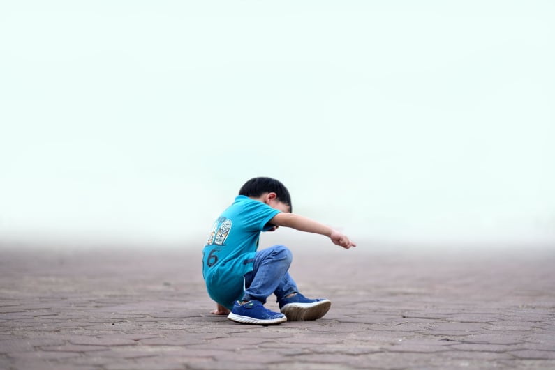 Child trying to stand up after falling down