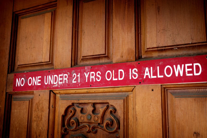 "No one under the age of 21 is allowed" Sign on the door