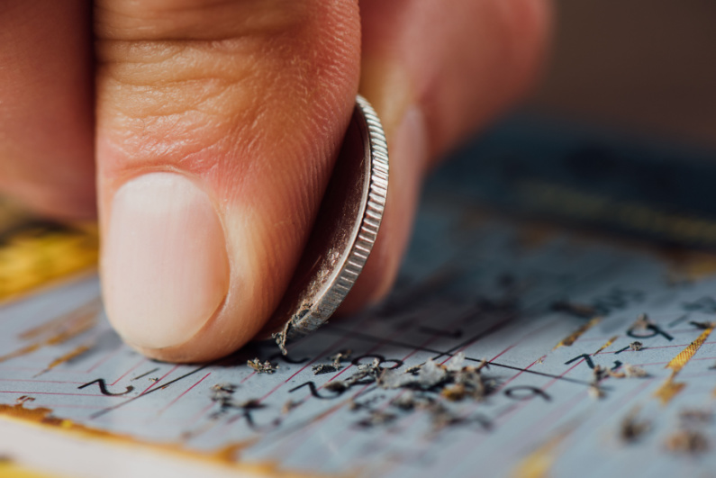 Person scratching lottery ticket