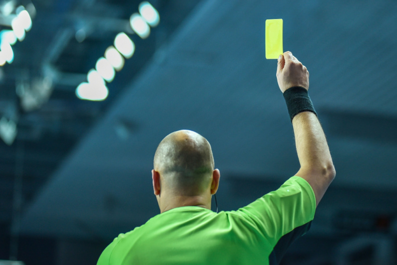 Referee showing yellow card