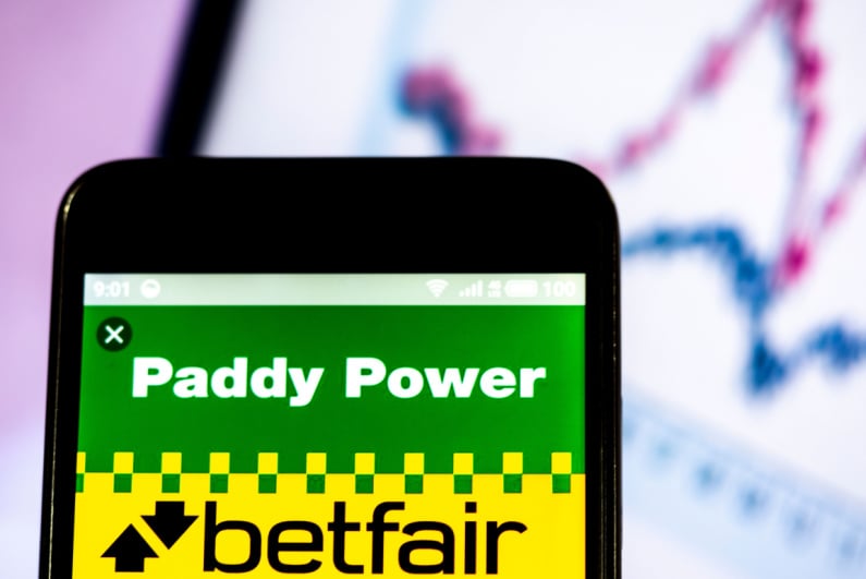 Paddy Power and Betfair logos on phone