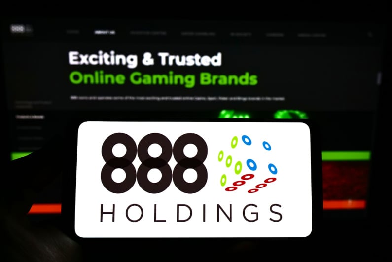 888 Holdings logo on a phone