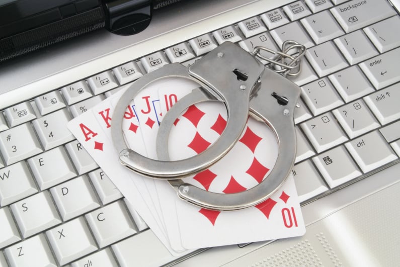 Handcuffs and playing cards on a keyboard