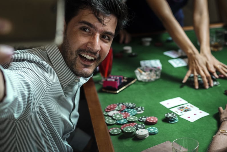 Man taking a selfie at a poker table