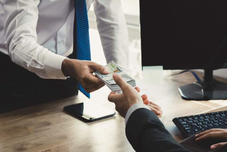 Businessmen exchanging cash