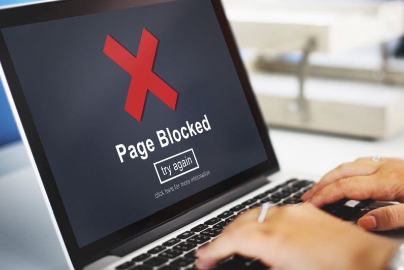 The page is blocked on the laptop