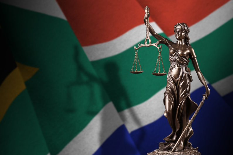 South African flag with statue of lady justice