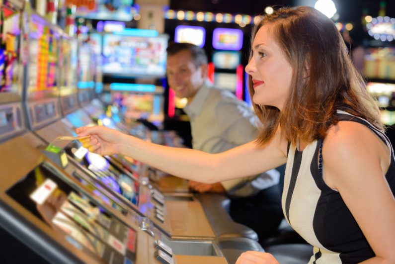 Woman playing a slot machine