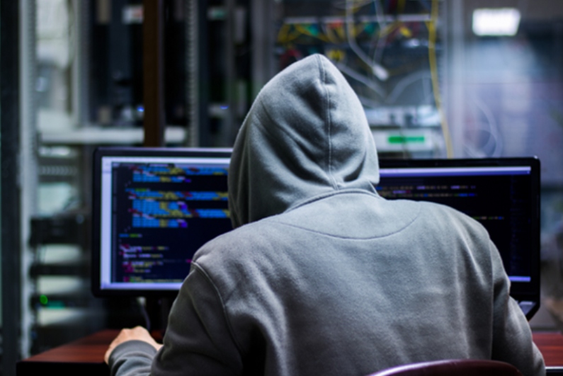 Hacker behind computer screen