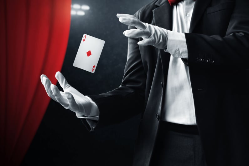 Magician levitating the Ace of diamonds