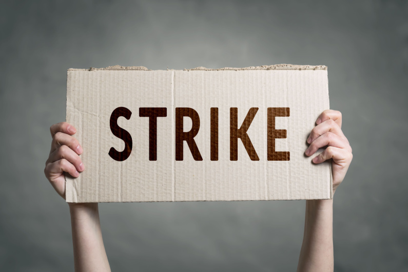 Person holding strike sign