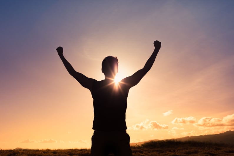 Hiker triumphant on top of mountain