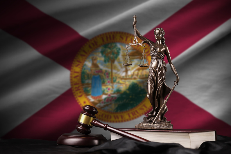 Lady Justice in front of Florida flag
