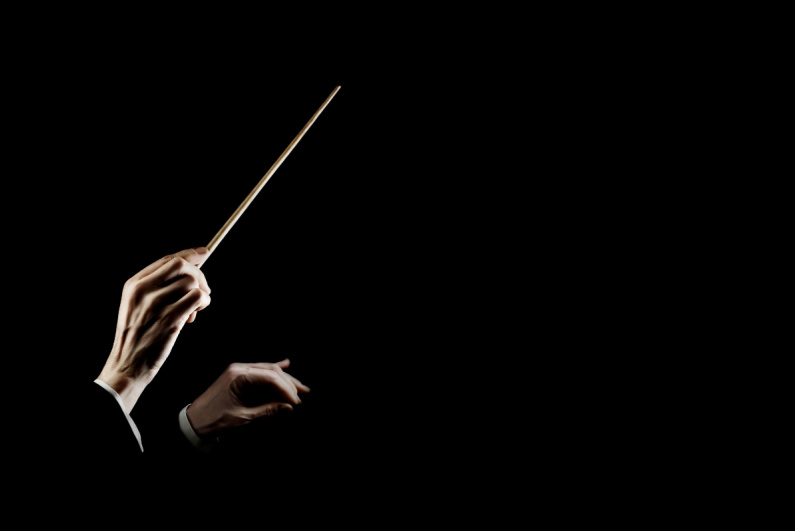 Orchestra conductor's hands with baton