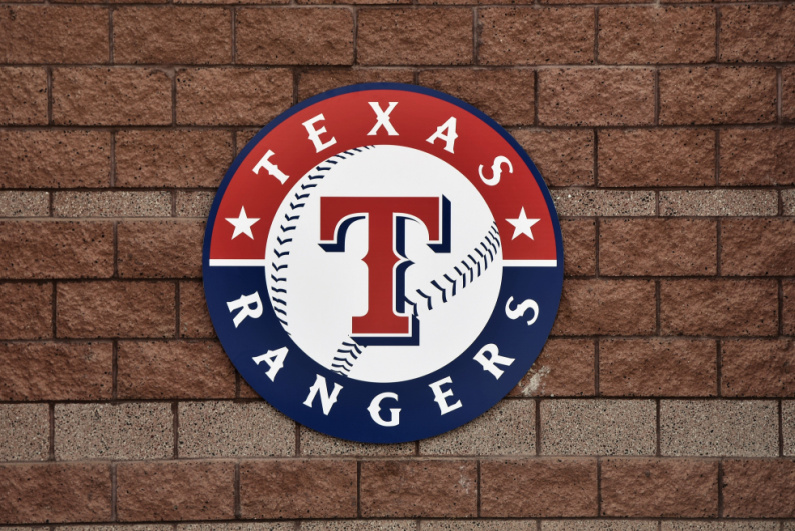 Texas Rangers logo on a brick wall
