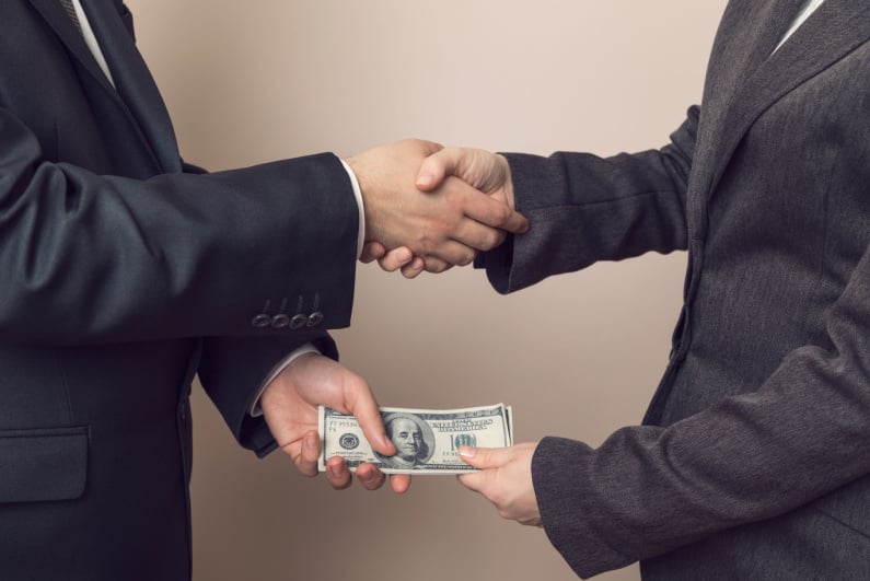 Businessmen exchange cash
