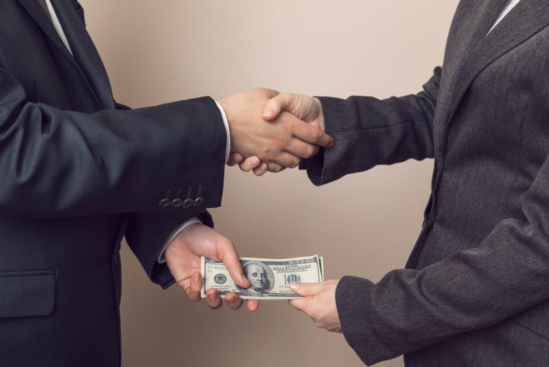 Businessmen exchanging cash