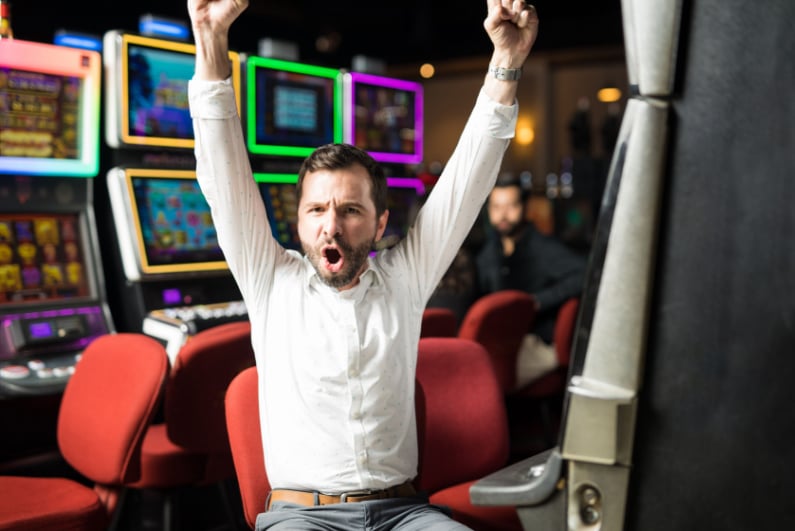 A man celebrates winning the slots