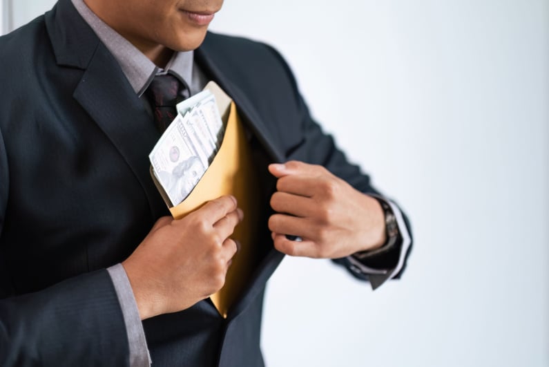 Businessman putting folder in pocket