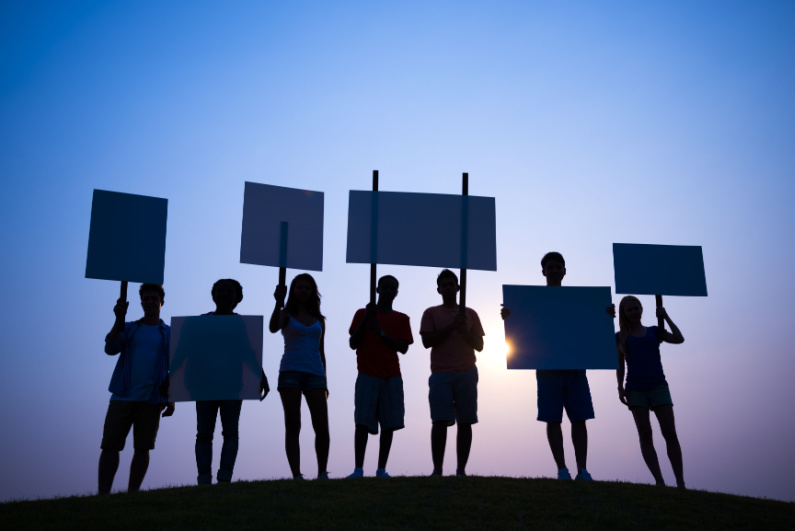 Silhouettes of people picketing